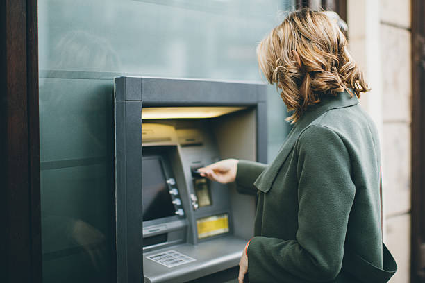 Young woman using a cash machine